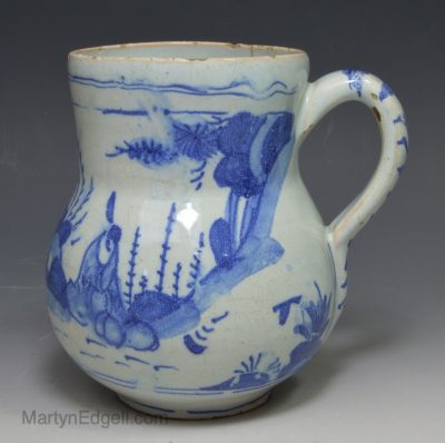 Lambeth delft jug painted landscape in blue, circa 1690