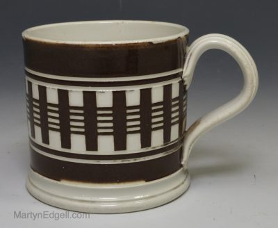 Small pearlware mug decorated with inlaid brown slip, circa 1840