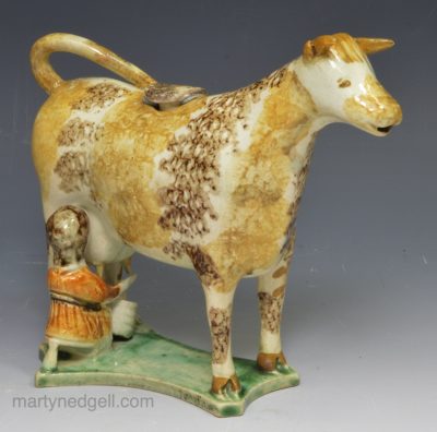 Pearlware pottery cow creamer decorated with sponging effect, circa 1820