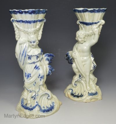 A pair of pearlware pottery moulded candle sticks, circa 1790