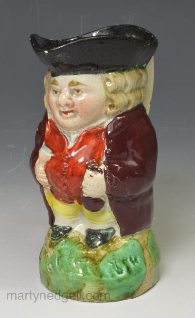 Staffordshire miniature pearlware pottery Toby jug decorated with enamels over the glaze, circa 1820