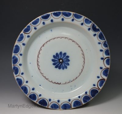 London delft pancake plate decorated in blue and manganese, circa 1750