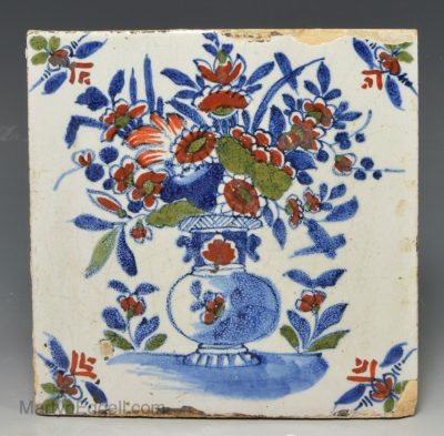 London delft tile decorated in blue, red and green florals, circa 1730