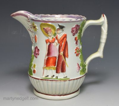 Pearlware pottery jug moulded with a couple, circa 1820
