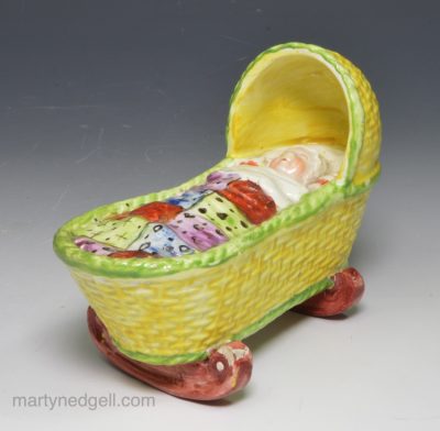 Pearlware pottery child’s toy cradle and baby, circa 1820