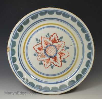 London delft plate painted with florals in red, blue and yellow, circa 1730