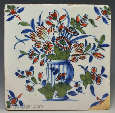 London delft tile decorated in blue, red and green florals, circa 1730