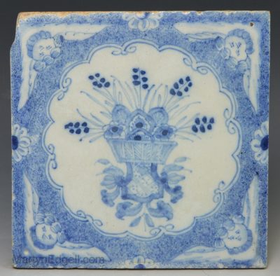 Liverpool delft tile decorated with angel head corners and florals, circa 1760