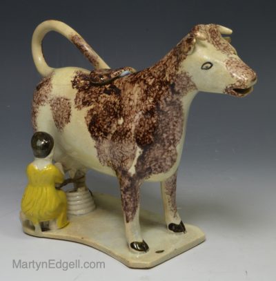 Pearlware pottery cow creamer decorated with sponging effect, circa 1820