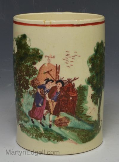 Small creamware pottery mug decorated with enamels over the glaze, circa 1790