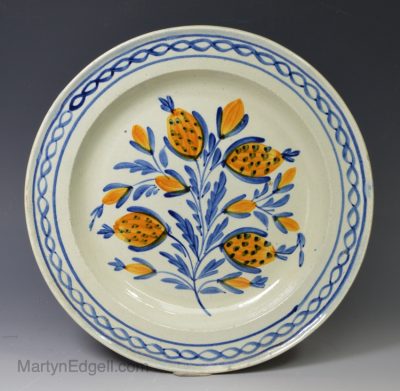 Pearlware pottery plate decorated in blue and orange under the glaze, circa 1820