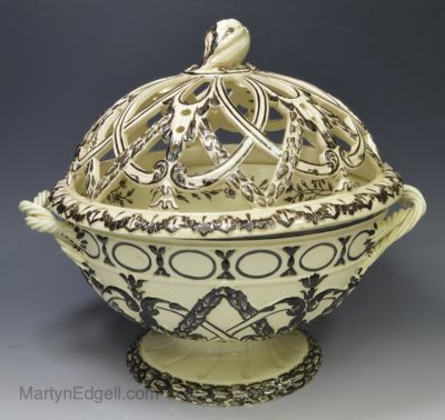 Wedgwood and Co creamware pottery bowl and pierced cover decorated with black enamels, dated 1786