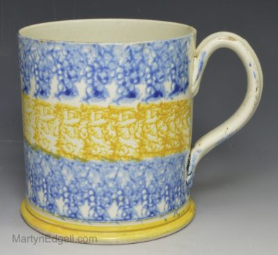 Spongeware pottery mug decorated in blue and yellow on a pearlware body, circa 1820