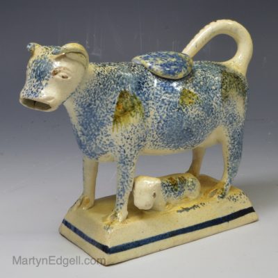 Pearlware pottery cow creamer decorated with sponging effect, circa 1820